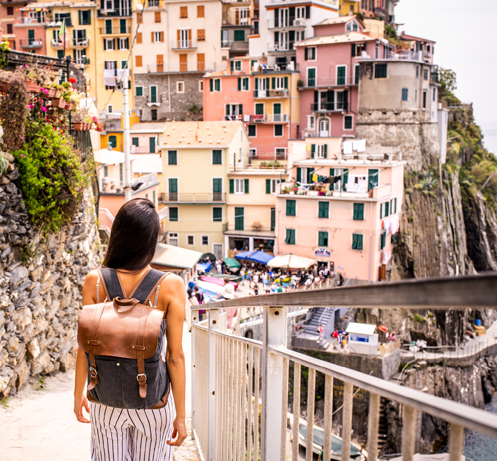 Woman visiting beautiful town in Cinque Terre coast, Italy.