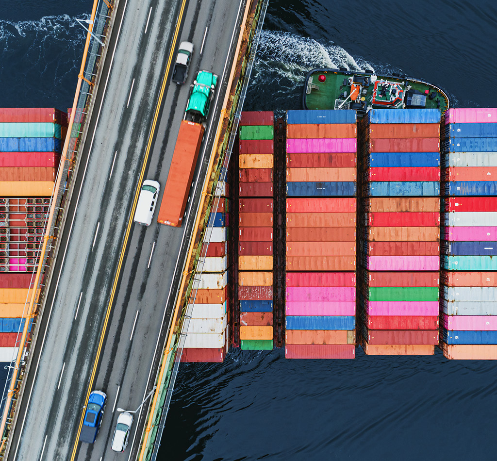 A container ship passes beneath a suspension bridge as it departs for Europe.