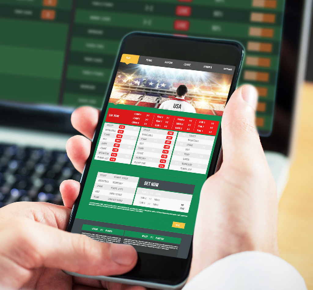 Using smartphone & laptop to view gambling app.