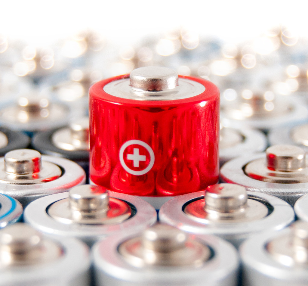Alkaline batteries with focus on a single red battery in the middle.