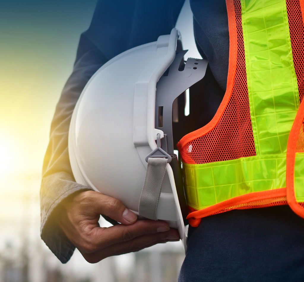 Technician holding a white hat safety hard hat.
