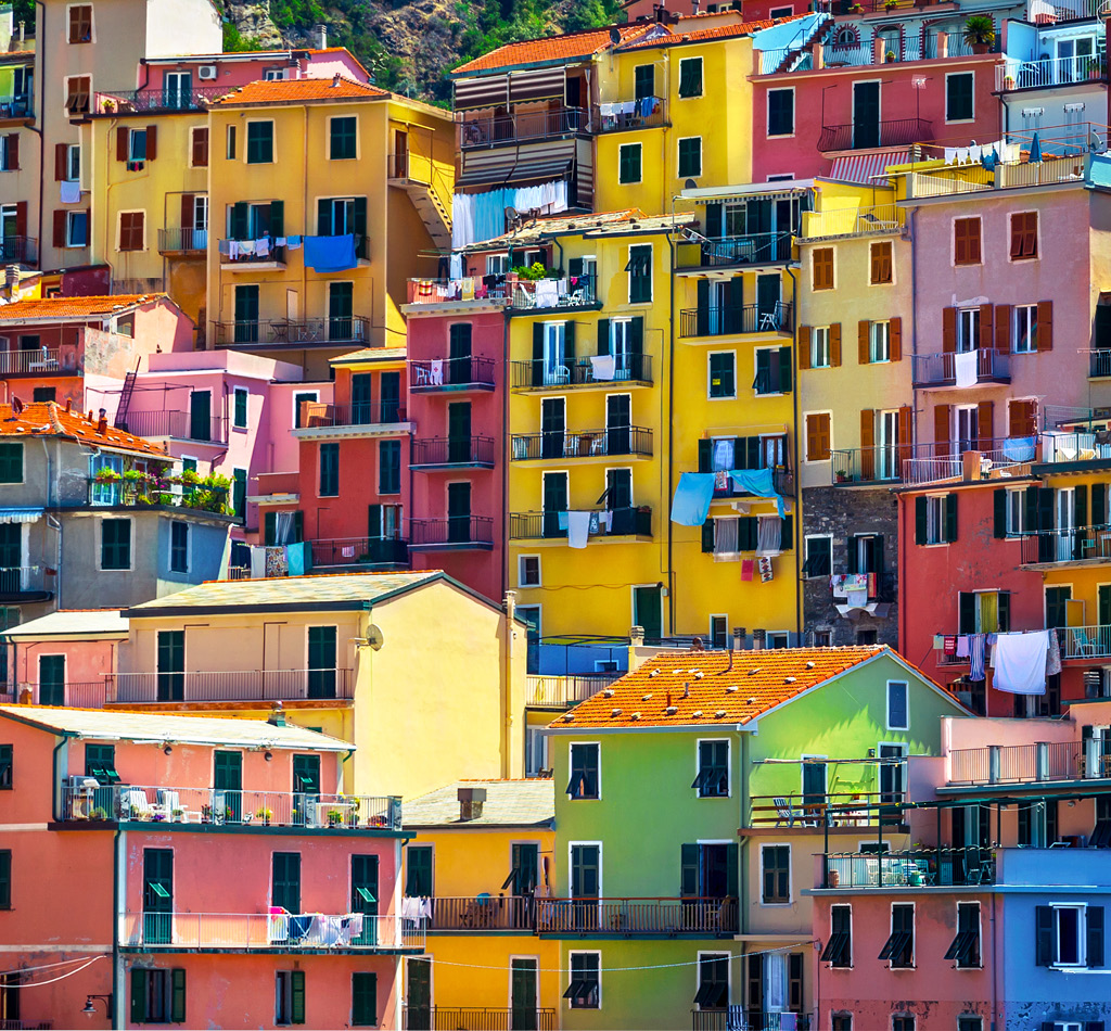 Colorful houses sit on a cliff in Cinque Terre (meaning “Five Lands”), in Liguria, Italy.